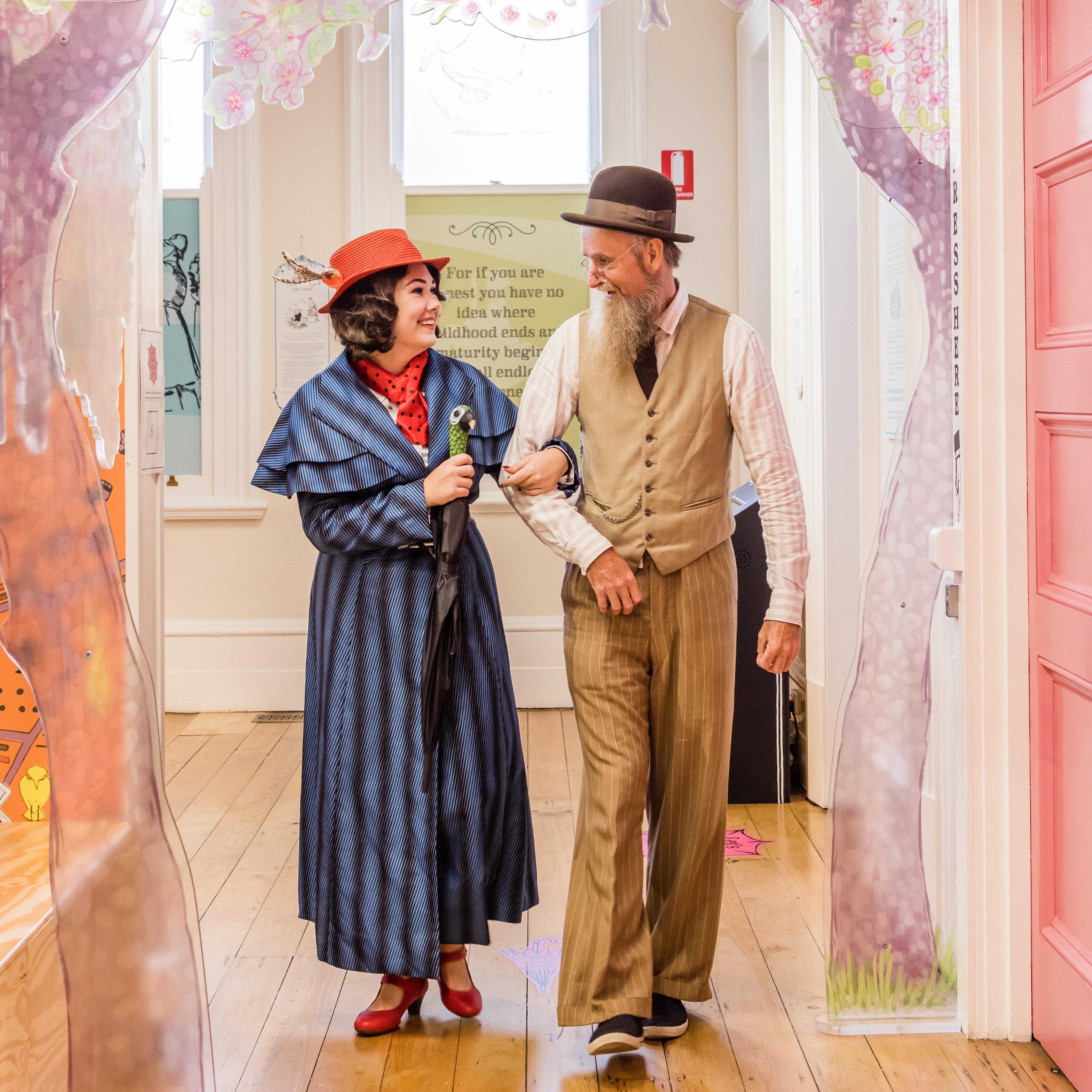 Mary Poppins and Mr Banks strolling down Cherry Tree Lane