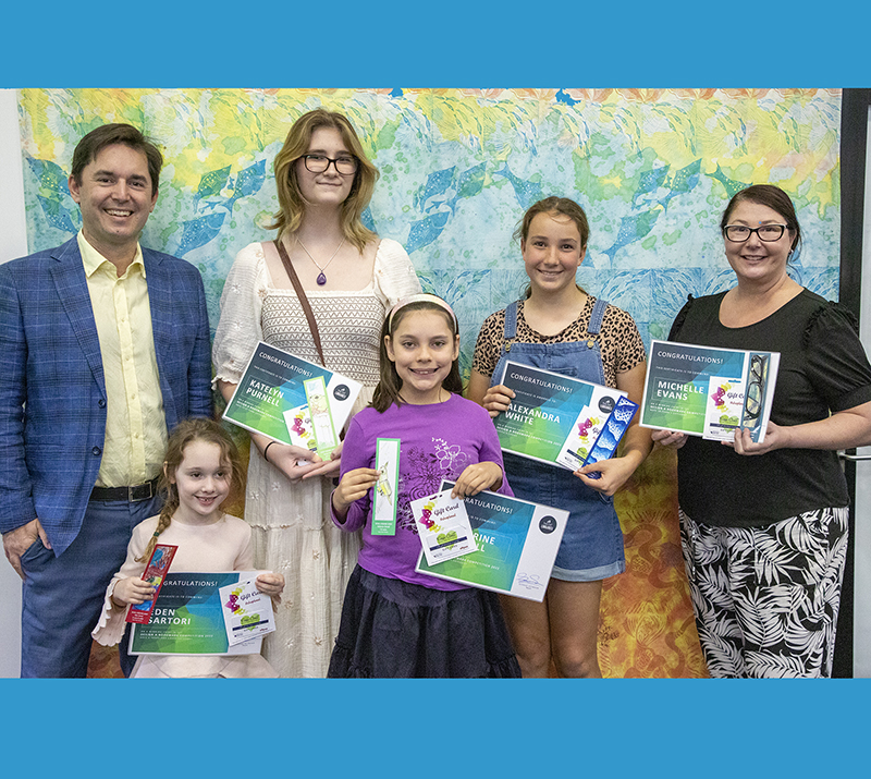 Fraser Coast Mayor George Seymour congratulates the winners of the 2022 design a bookmark competition Katelyn Purnell, Alexandra White, Michelle Evans, (front) Eden Sartori and Catherine Cottrell.